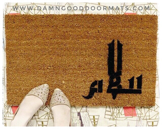 Promotional graphic for an eco-friendly coir doormat made by Damn Good Doormats reading Salaam in Arabic calligraphy